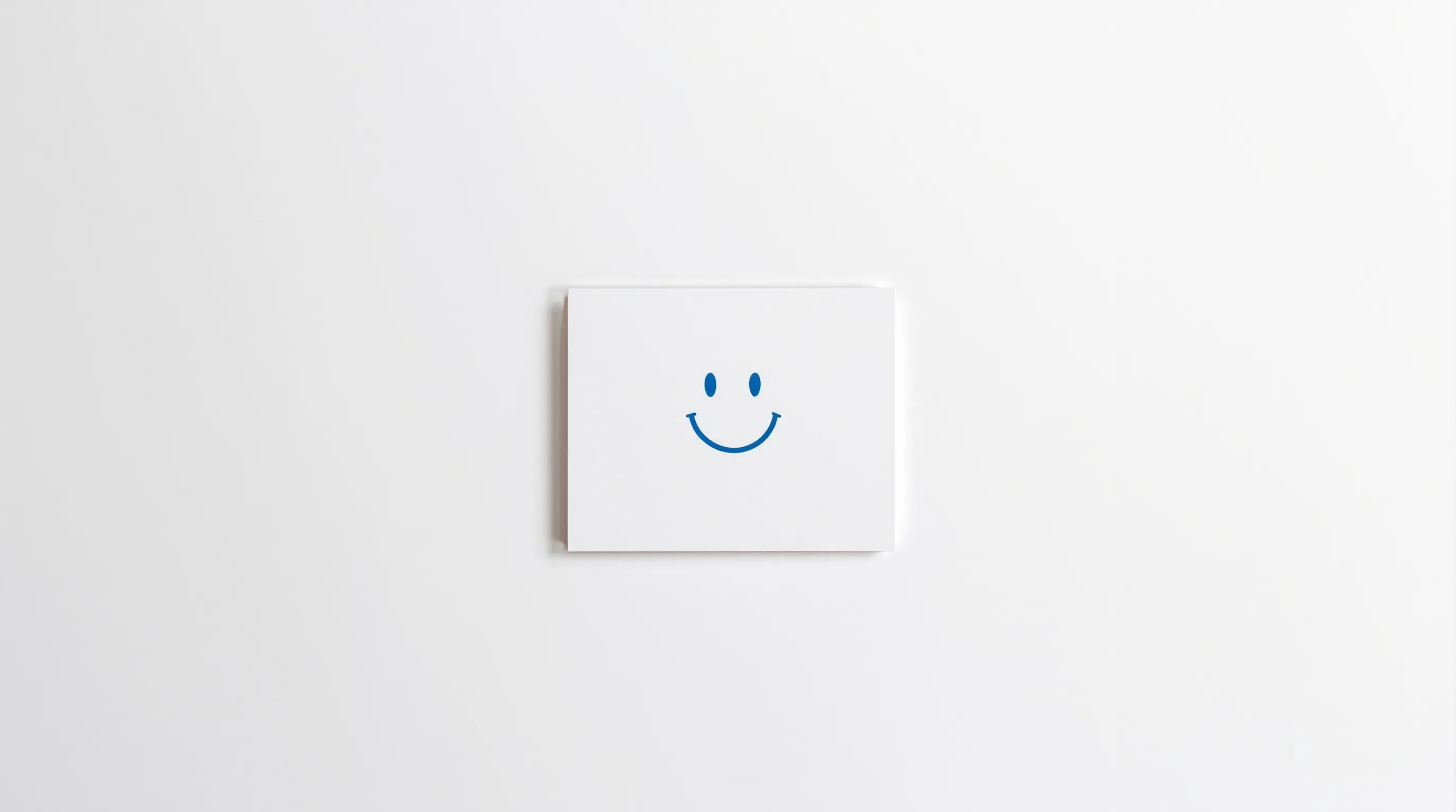 a minimal birthday card with a smiling face and cheerful blue accent
