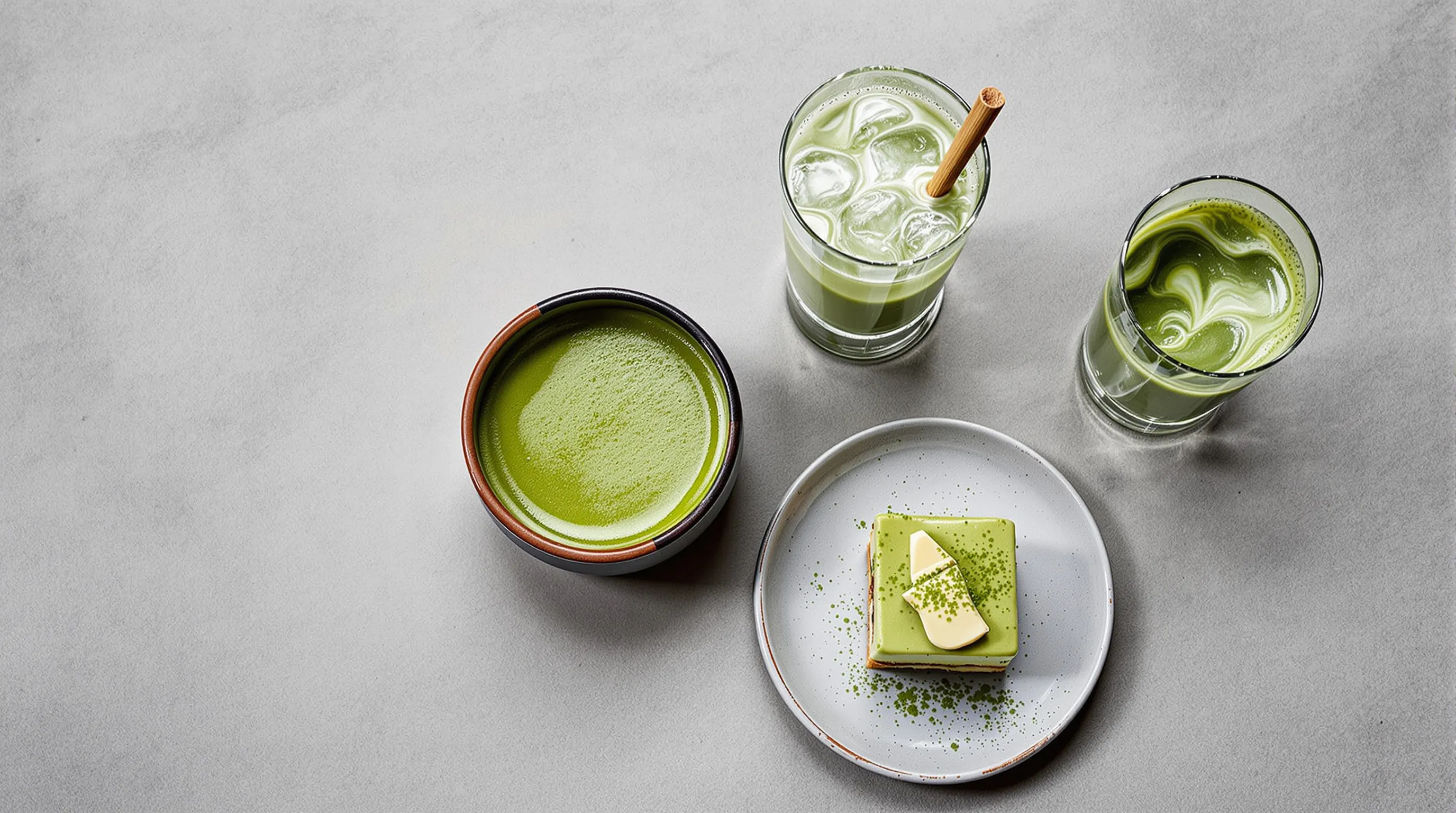 Two matcha bowls—thin and thick—surrounded by latte, iced drink, and pairings.
