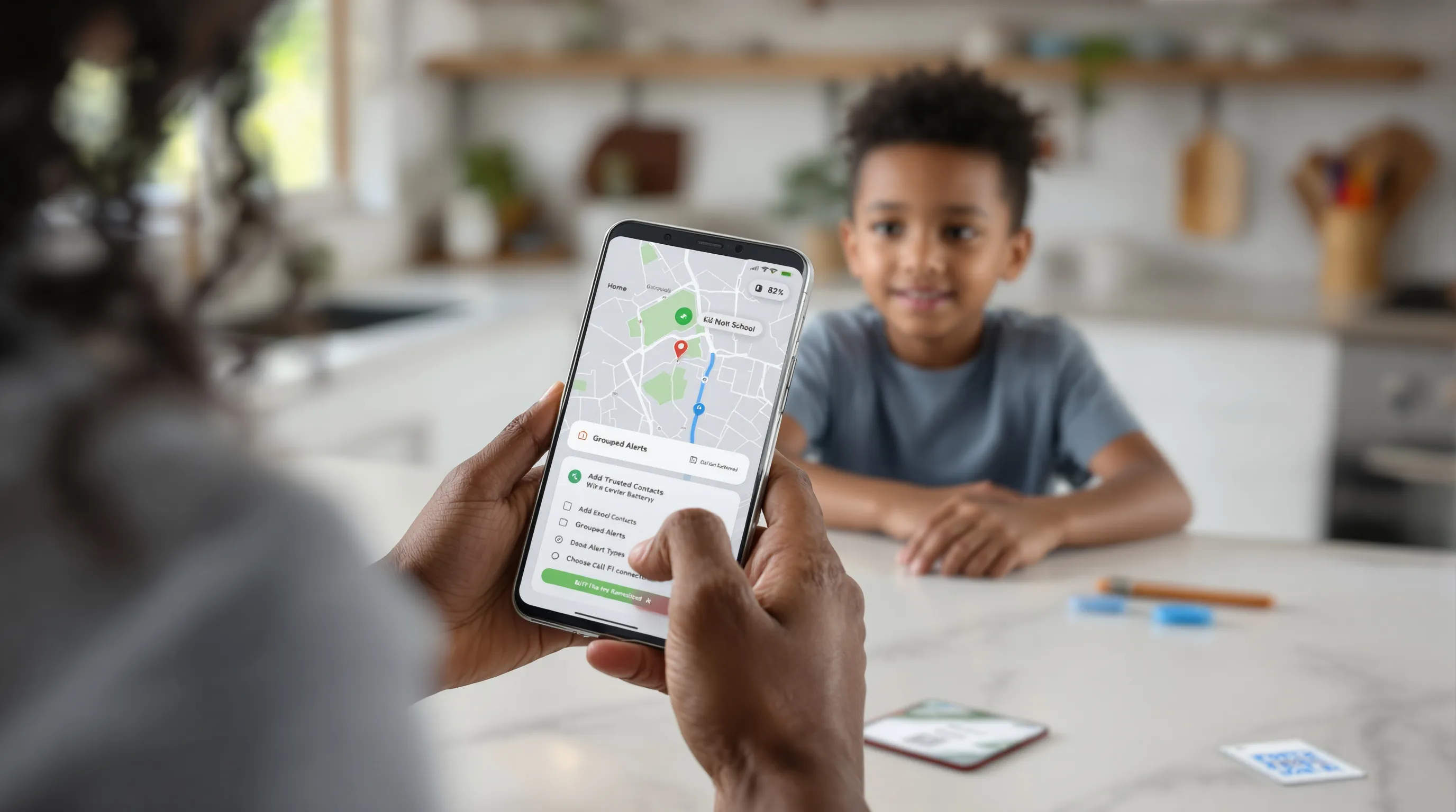 Parent configures a kid’s GPS smartwatch app at home with geofences.