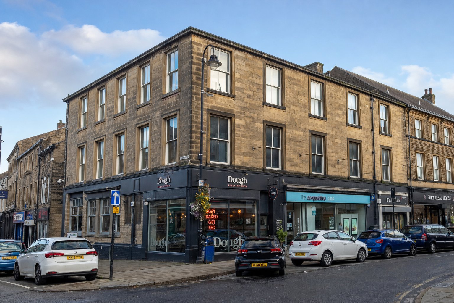 Mixed-use commercial property on a Bury street photographed in soft daylight.