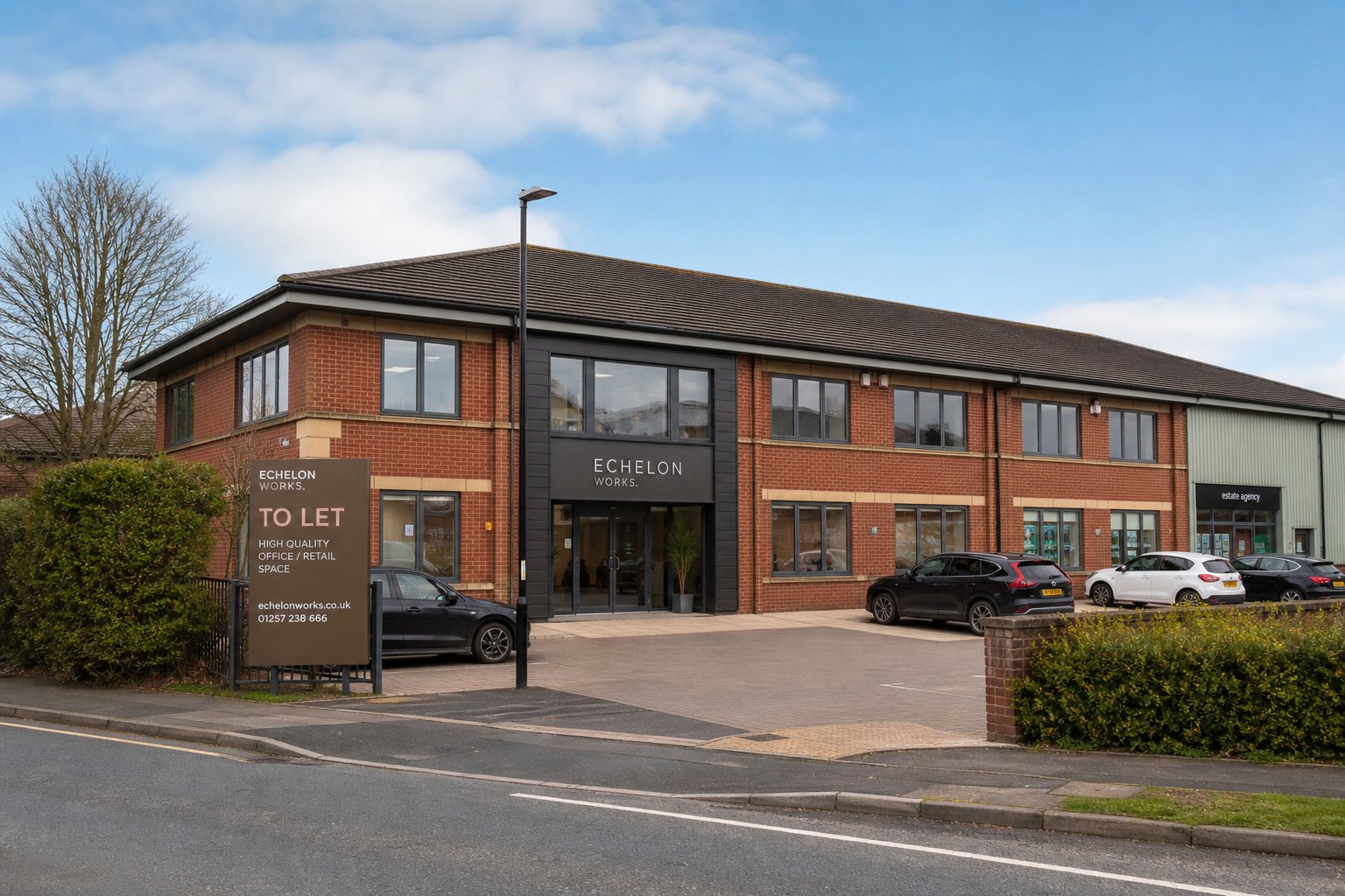 Street-level view of a well-kept commercial building in Chorley on a clear day with parked cars outside.